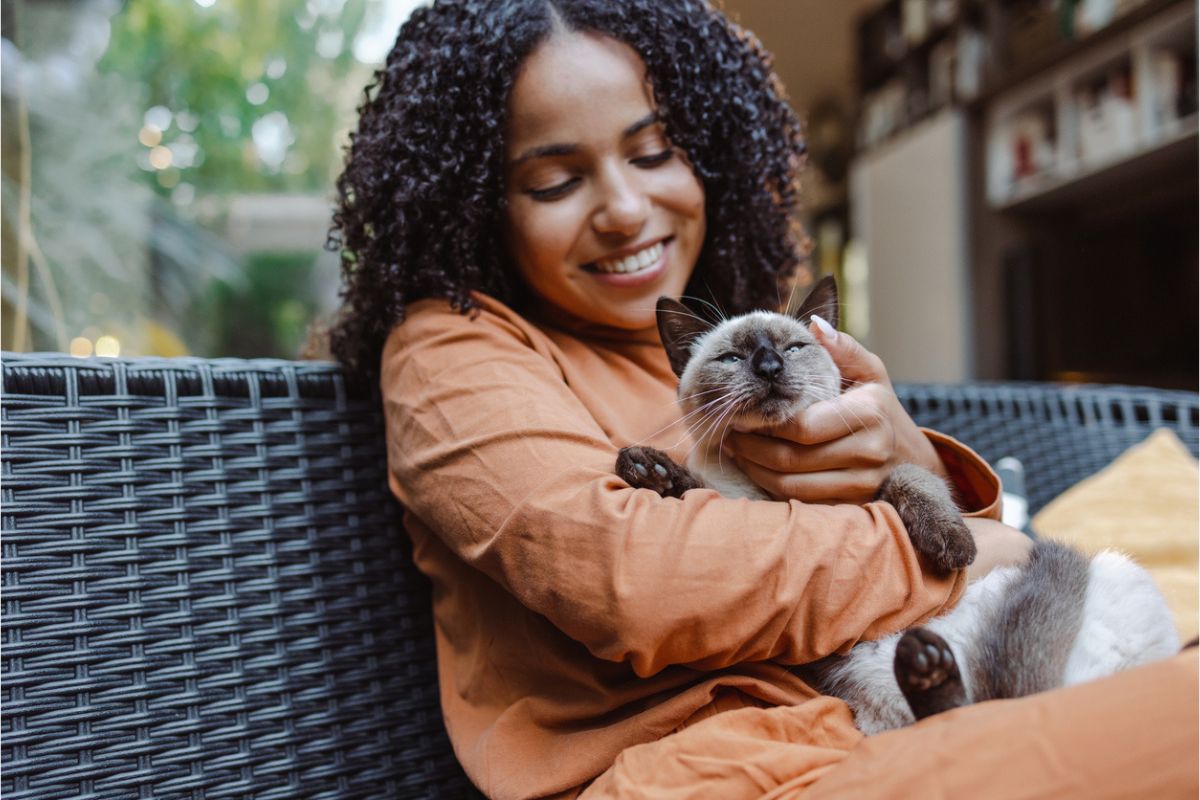 Human-cuddling-cat Lady cuddling cat